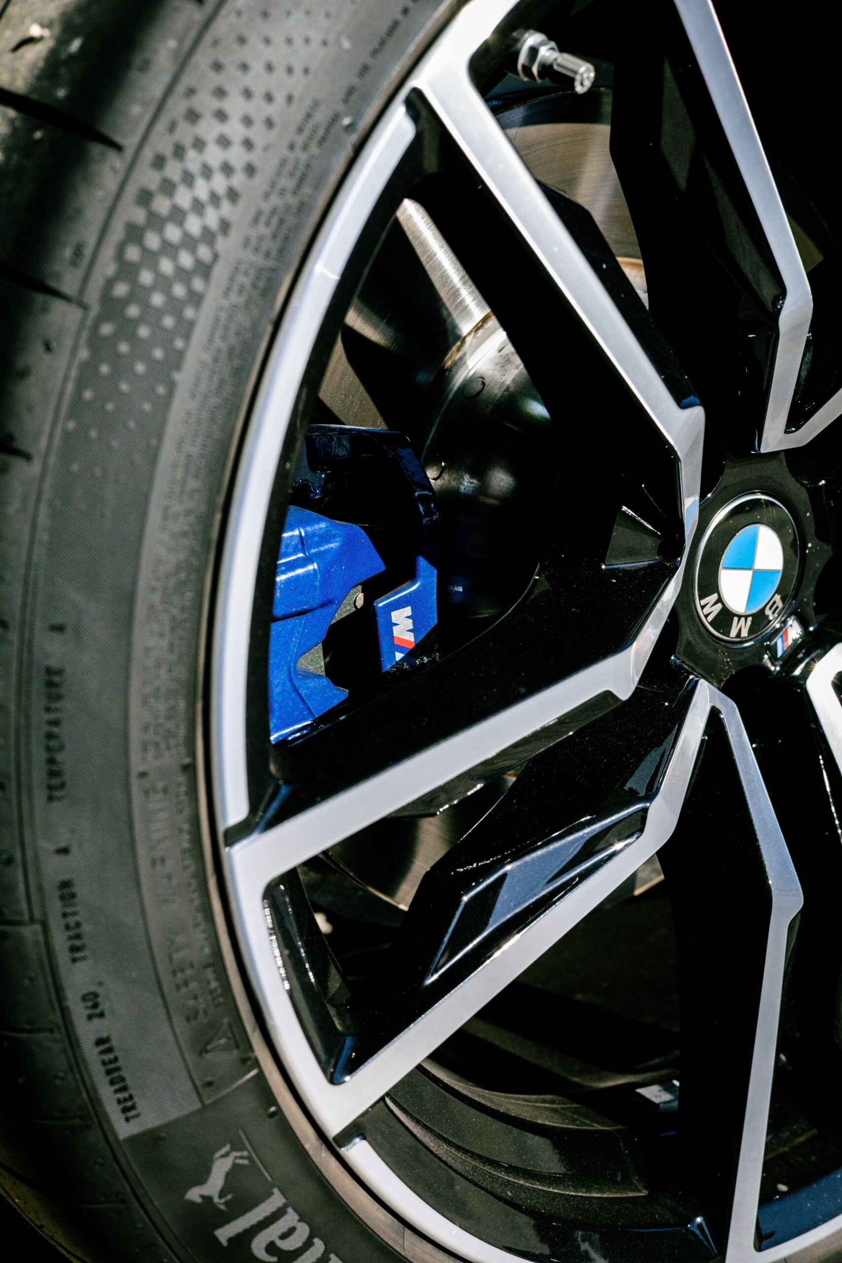 Detailed close-up of a BMW vehicle's wheel showcasing the tire and brake components.